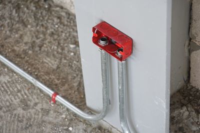 High angle view of red electric pipe on wall