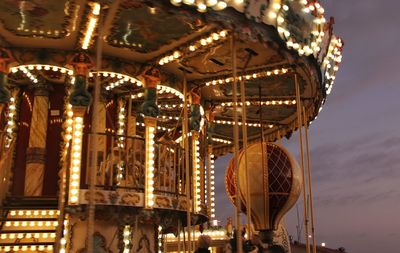 Low angle view of illuminated ferris wheel at night