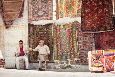 Full length of a young woman sitting outdoors