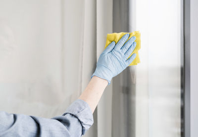 Midsection of man working in window