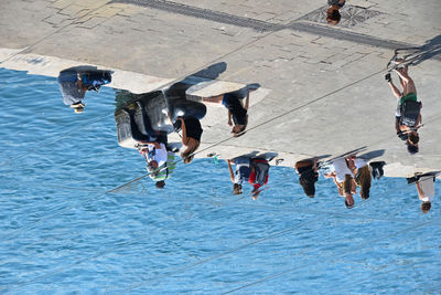 High angle view of people sitting on promenade in city