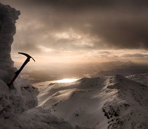 Scenic view of mountains against cloudy sky