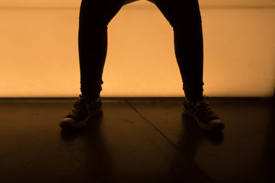 Low section of woman standing on tiled floor