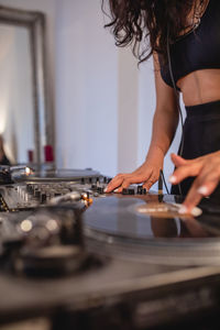 Fashionable young woman playing music at home