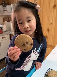 Portrait of girl holding toy at home