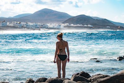 Full length of woman standing at beach