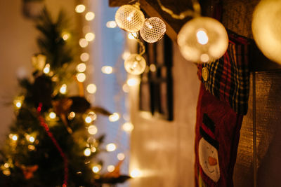 Close-up of illuminated christmas lights hanging on wood