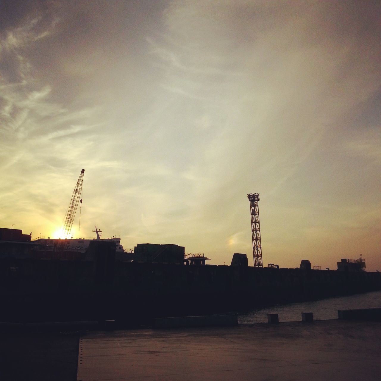 architecture, building exterior, built structure, sunset, sky, silhouette, crane - construction machinery, construction site, crane, cloud - sky, low angle view, industry, city, development, building, orange color, outdoors, dusk, construction, cloud