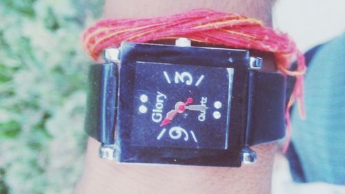 Close-up of hand holding clock