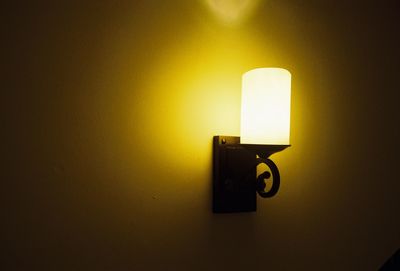 Close-up of illuminated lamp on wall