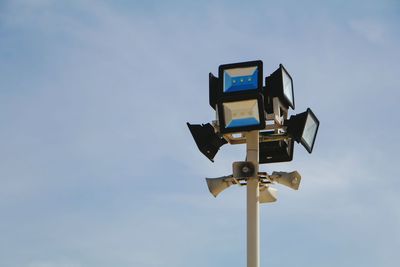 Low angle view of floodlight against sky