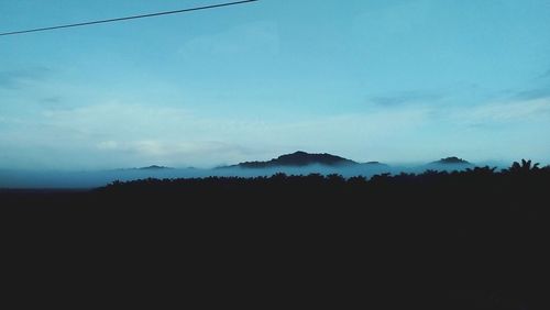 Scenic view of silhouette mountains against sky