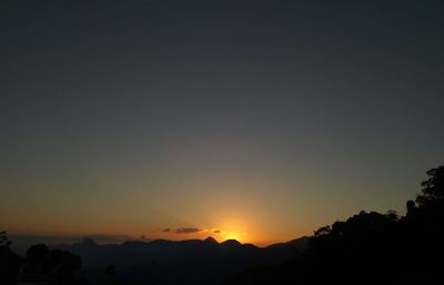 Scenic view of silhouette mountains against clear sky