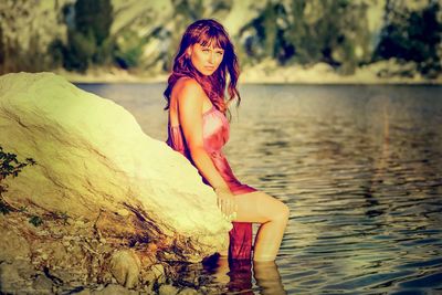 Young woman looking at lake