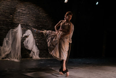 Portrait of young woman dancing in water