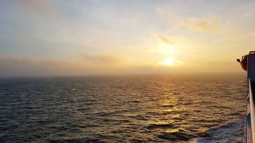 View of sea against cloudy sky during sunset