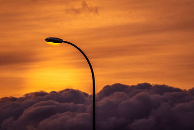 Low angle view of street light against orange sky