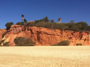 Scenic view of rocky mountains against clear blue sky