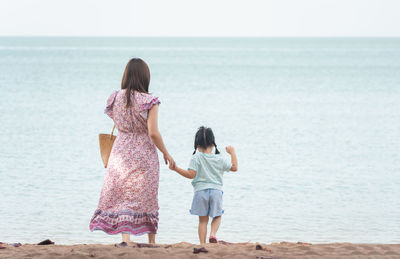 Friends standing at beach