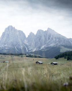 Scenic view of landscape and mountains against cloudy sky