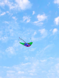 Low angle view of kite flying against blue sky