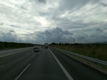 Cars on highway against sky