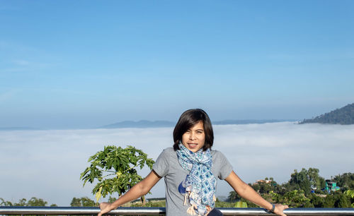 Portrait of woman against blue sky