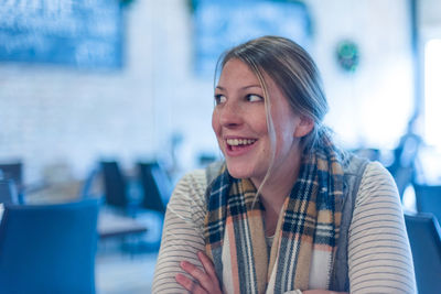 Close-up of smiling beautiful woman looking away