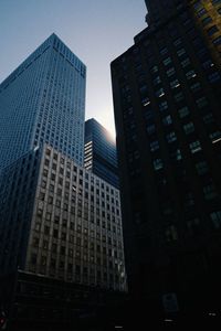 Low angle view of skyscrapers against sky at night