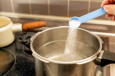 Close-up of hand holding ice cream at home