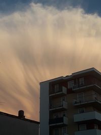 Low angle view of building against sky at sunset