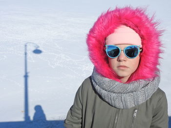 Portrait of girl wearing warm clothing and sunglasses during winter