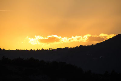 Scenic view of silhouette trees against sky during sunset