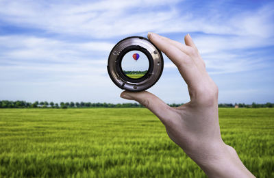 Close-up of woman holding camera