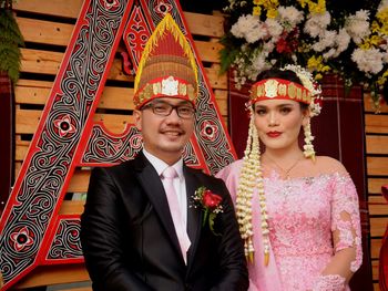 Portrait of smiling couple during wedding ceremony