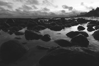 Rocks on beach against sky