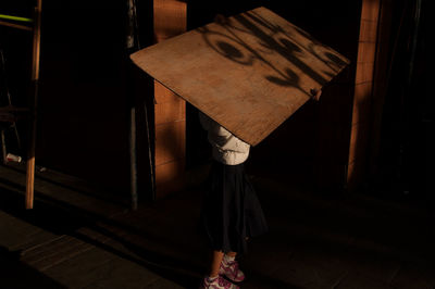 Low section of woman standing on wooden floor