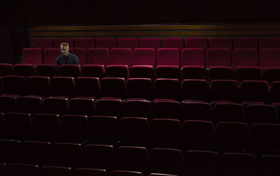 Rear view of man sitting on chair