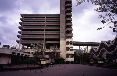 Buildings against cloudy sky