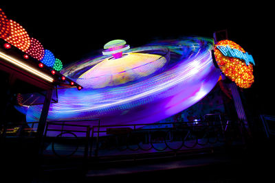 Illuminated ferris wheel at night