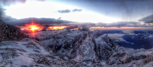 Sun shining over snowcapped mountains
