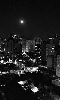 High angle view of illuminated buildings against sky at night