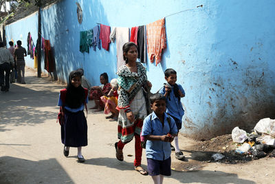 Rear view of people standing on floor