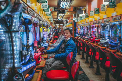 Portrait of smiling young man sitting at market