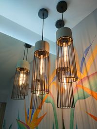 Low angle view of illuminated pendant light at home