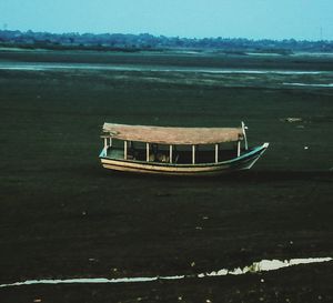 Boat moored on sea against sky