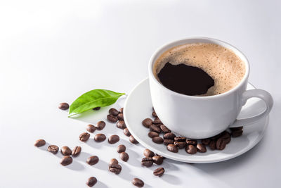 Close-up of coffee cup over white background