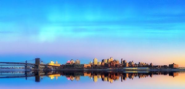 Illuminated buildings against clear sky at dusk