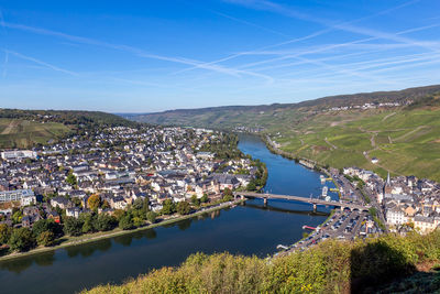 High angle view of river by townscape against sky