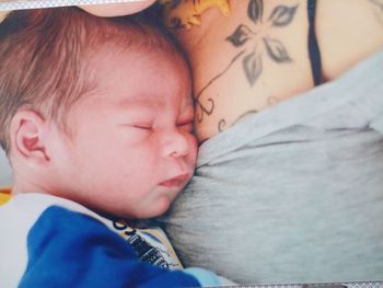 Close-up of baby sleeping on bed